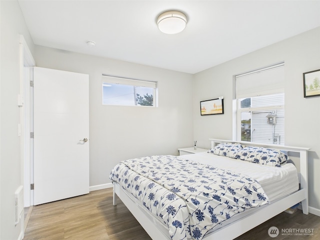 bedroom featuring baseboards and wood finished floors