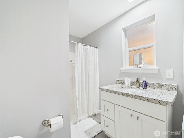 full bathroom with a shower with curtain and vanity