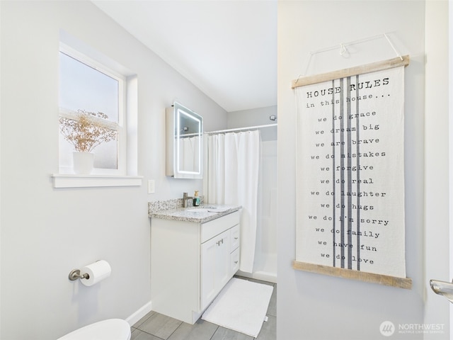 bathroom with toilet, curtained shower, and vanity