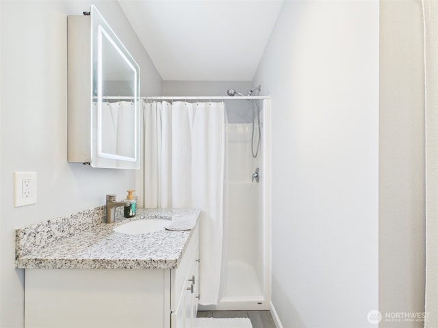 full bathroom with curtained shower and vanity