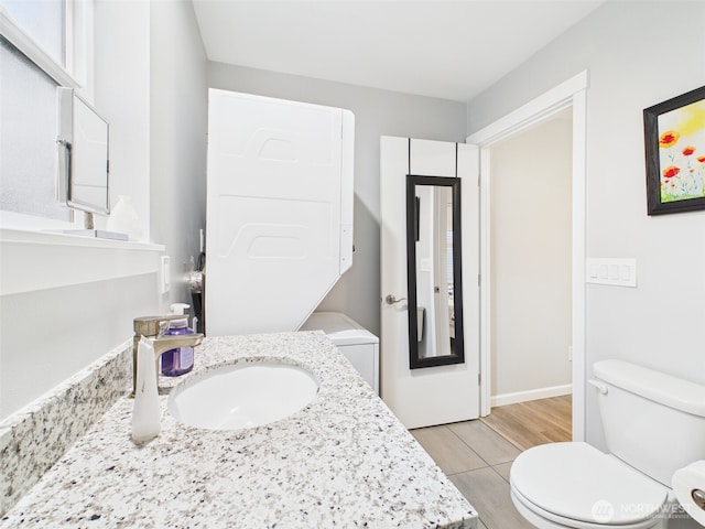 bathroom featuring toilet and vanity