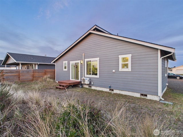 back of property featuring ac unit, crawl space, and fence