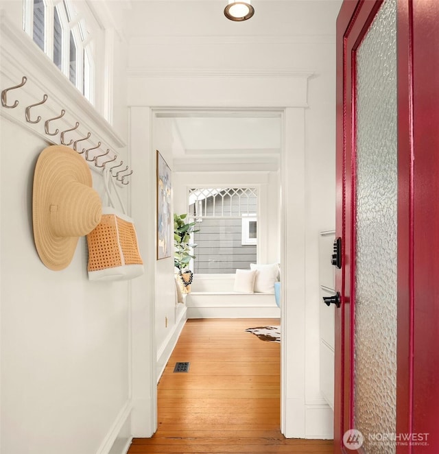 hallway with visible vents and wood-type flooring