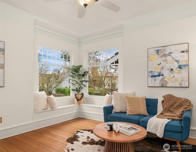 sitting room with wood-type flooring and ceiling fan