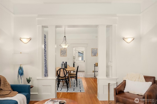 interior space featuring light wood-type flooring and ornamental molding