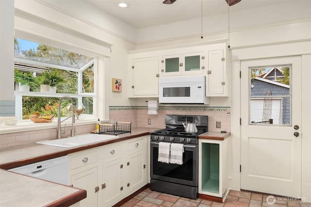 kitchen featuring a sink, backsplash, recessed lighting, white appliances, and white cabinets