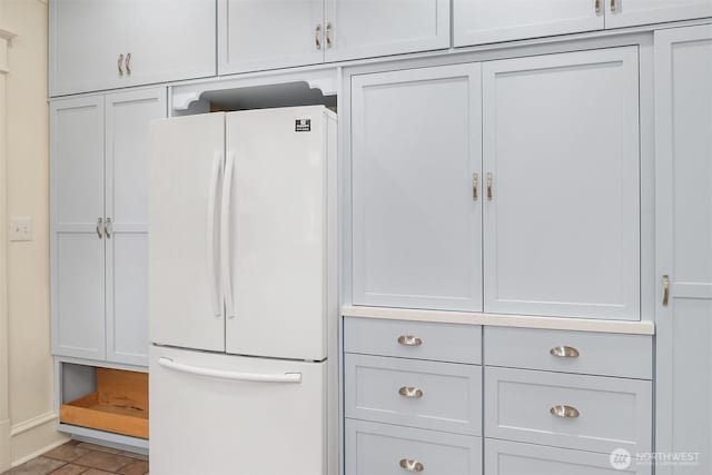 kitchen with freestanding refrigerator