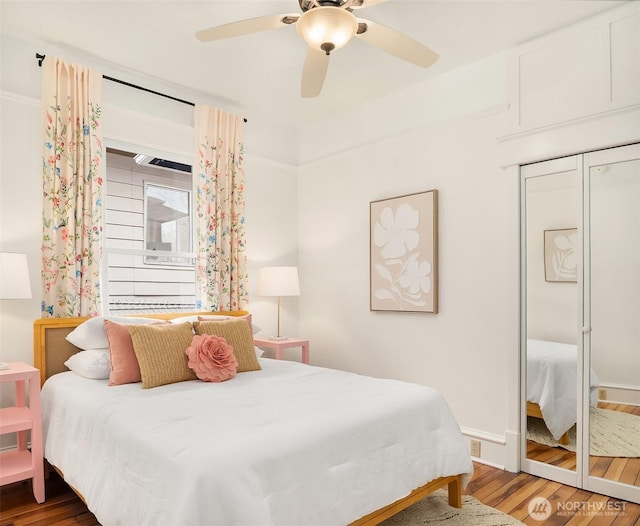 bedroom with a ceiling fan and wood finished floors