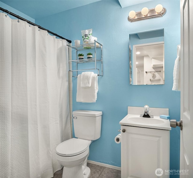 bathroom with vanity, tile patterned floors, toilet, and baseboards