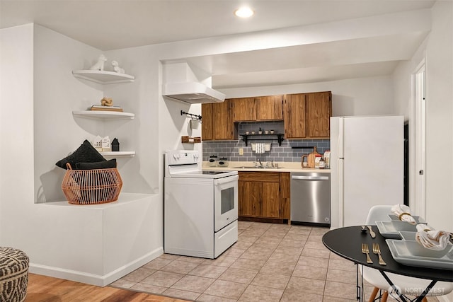 kitchen with white appliances, brown cabinets, open shelves, and a sink