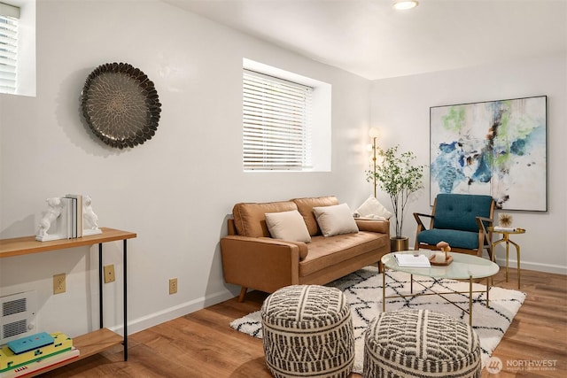 living area featuring recessed lighting, baseboards, and wood finished floors