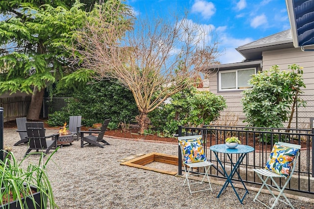 view of yard with a patio, a fire pit, and fence