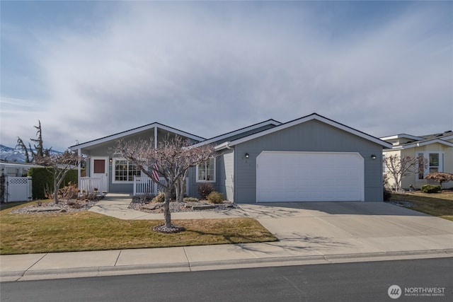 view of front of property with a porch, an attached garage, driveway, and a front lawn