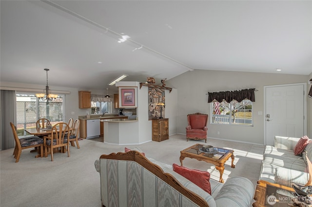 living room with a wealth of natural light, baseboards, light colored carpet, and vaulted ceiling