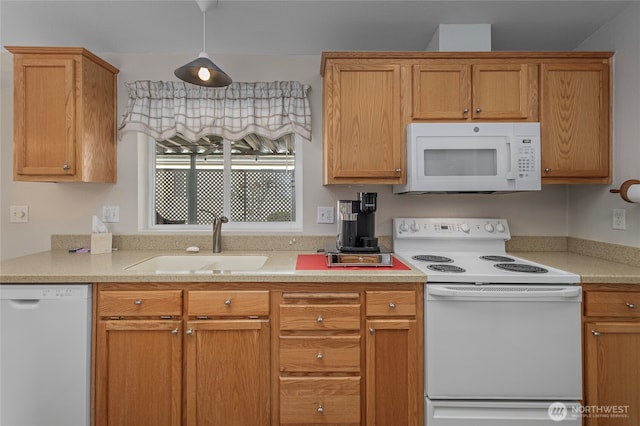 kitchen with white appliances, light countertops, and a sink