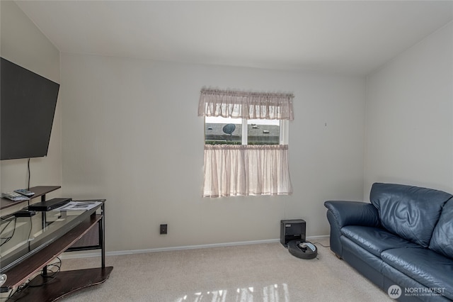 carpeted living area featuring baseboards