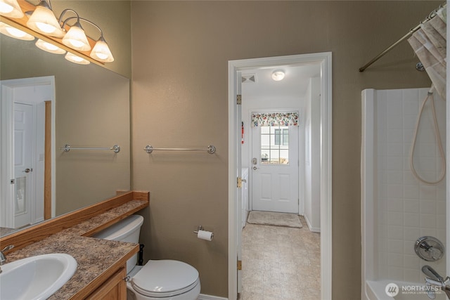 full bath featuring toilet, vanity, and shower / bath combo