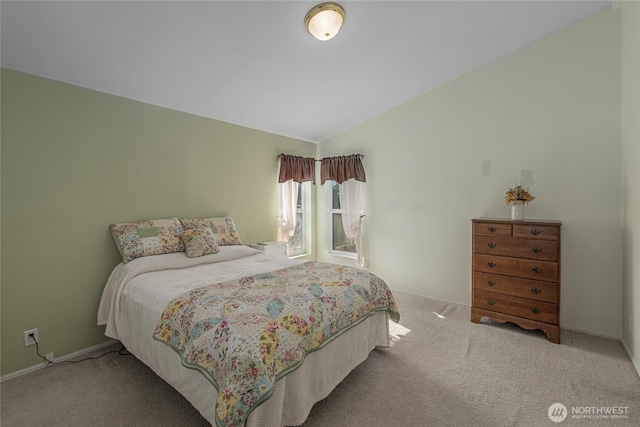 bedroom featuring baseboards, carpet, and vaulted ceiling