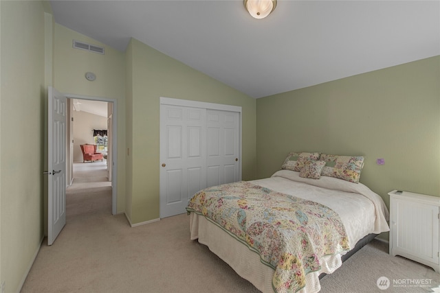 bedroom featuring visible vents, light carpet, a closet, radiator, and vaulted ceiling