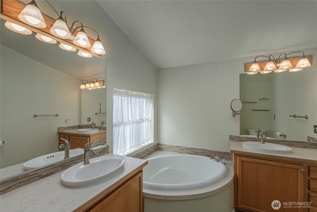 bathroom with two vanities, lofted ceiling, and a sink