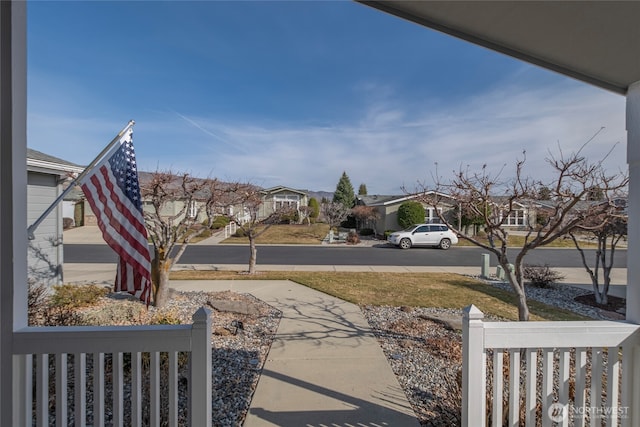 view of yard with a residential view and fence