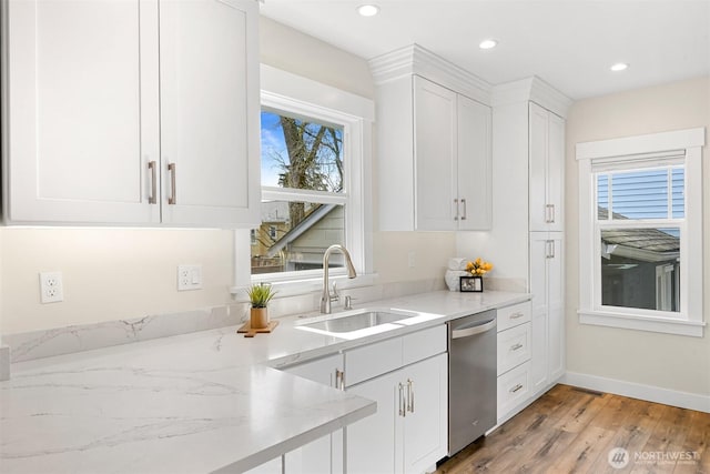 kitchen with recessed lighting, stainless steel dishwasher, light wood-style floors, white cabinetry, and a sink