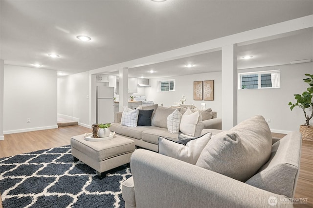 living room with recessed lighting, light wood-style flooring, and baseboards