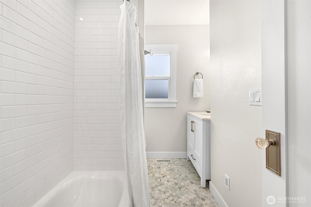 full bath with vanity, baseboards, and shower / bath combo with shower curtain