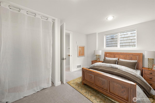 carpeted bedroom featuring visible vents and baseboards