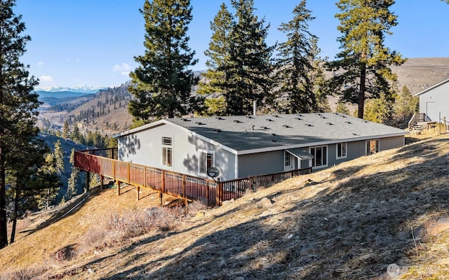 back of house featuring a deck with mountain view