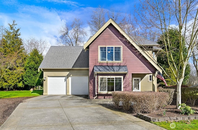 view of front of home featuring a garage, concrete driveway, and a shingled roof