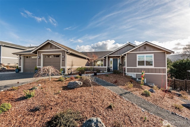 view of front of home with an attached garage, board and batten siding, and driveway