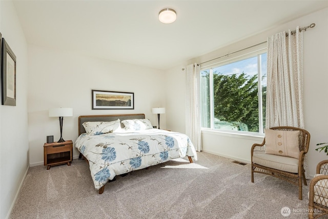 carpeted bedroom with baseboards and visible vents