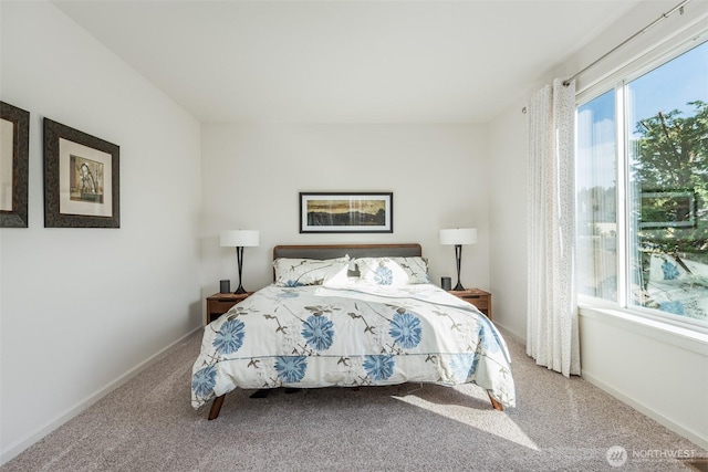 carpeted bedroom featuring baseboards