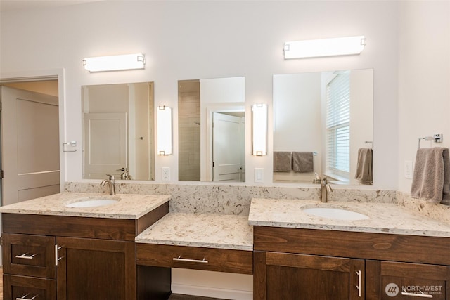 full bathroom with two vanities and a sink