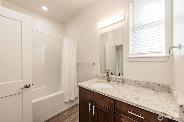 bathroom featuring shower / tub combo with curtain, wood finished floors, and vanity