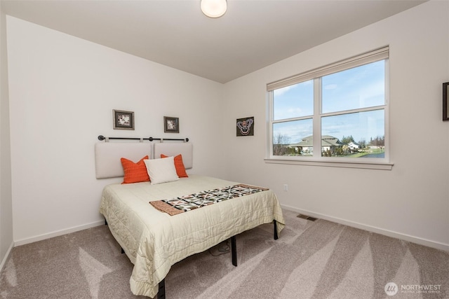 bedroom featuring baseboards, carpet floors, and visible vents