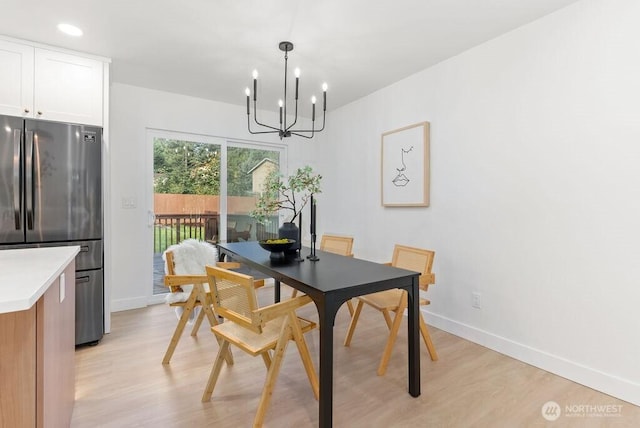 dining area featuring recessed lighting, baseboards, a notable chandelier, and light wood finished floors