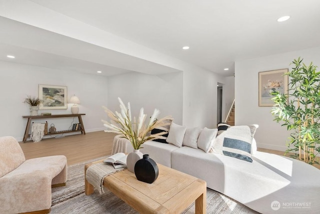 living area with stairs, recessed lighting, baseboards, and wood finished floors