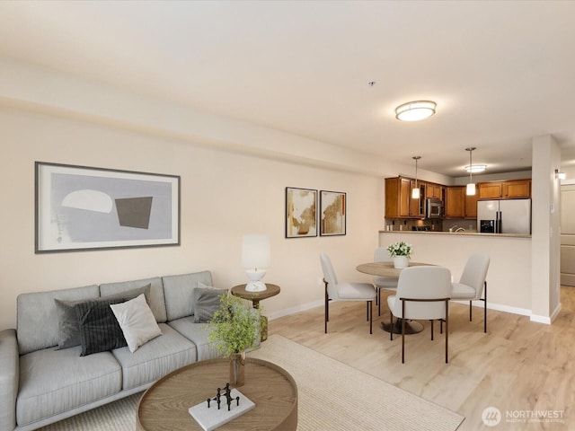 living room featuring light wood-style flooring and baseboards