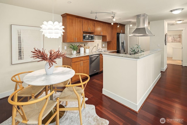 kitchen with brown cabinets, island exhaust hood, stainless steel appliances, dark wood-type flooring, and a sink