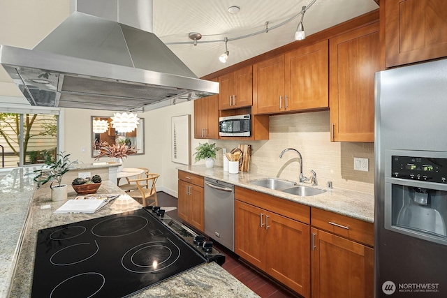 kitchen featuring stainless steel appliances, a sink, backsplash, light stone countertops, and island exhaust hood