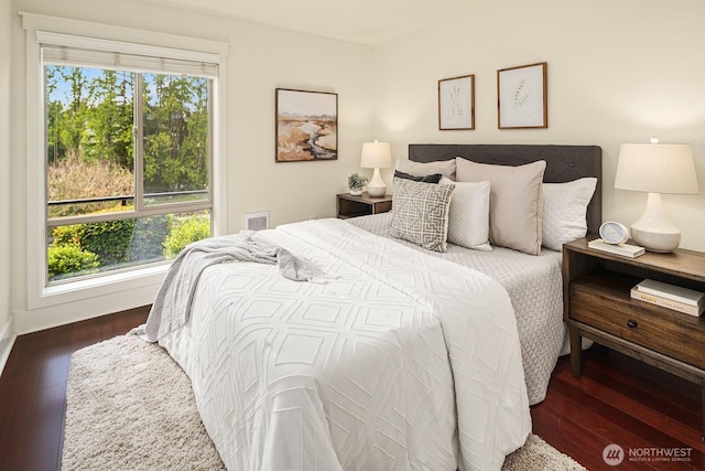 bedroom with visible vents and wood finished floors