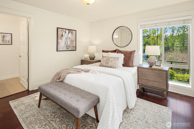 bedroom featuring wood finished floors and baseboards