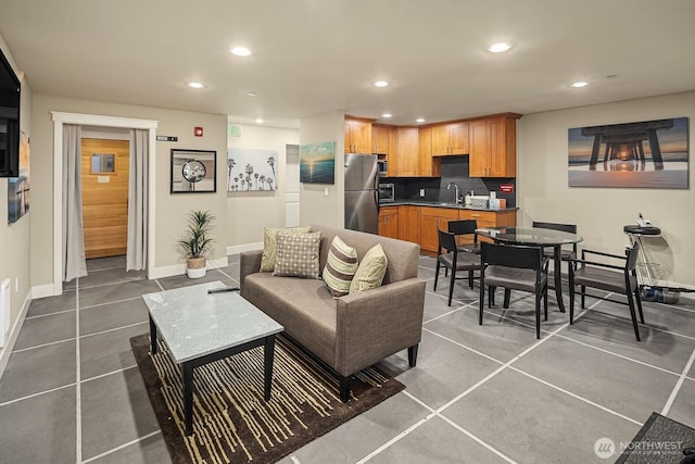 living room featuring baseboards, tile patterned flooring, and recessed lighting