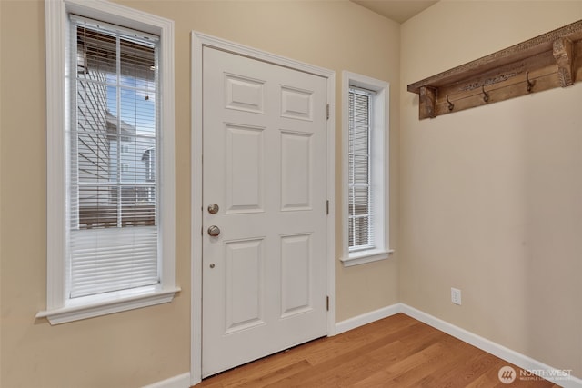 entrance foyer with light wood-type flooring and baseboards