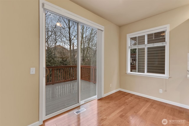 interior space featuring visible vents, baseboards, and hardwood / wood-style flooring