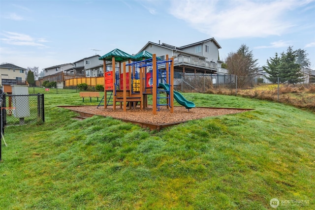 community jungle gym with a yard and fence