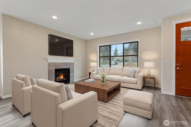 living area with recessed lighting, wood finished floors, and baseboards