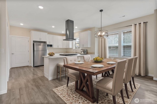 dining room with recessed lighting, visible vents, light wood finished floors, and baseboards